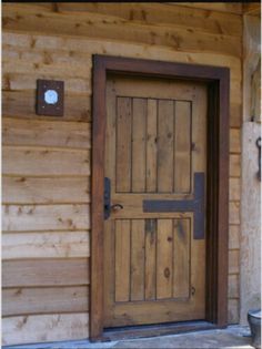 a wooden door on the side of a building