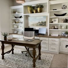 a home office with built in shelving and desk