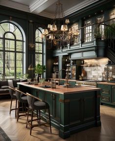 an elegant kitchen with green cabinets and wooden floors, chandelier above the island