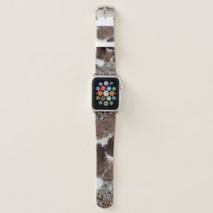 an apple watch sitting on top of a white table next to a brown and white wall