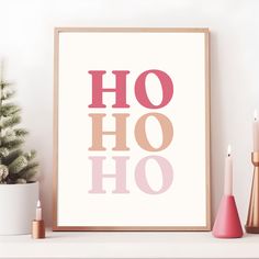 a poster with the words ho ho on it next to candles and a potted plant