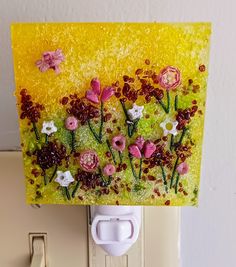 a light switch cover with flowers painted on it