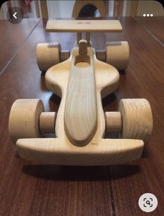 a wooden toy car sitting on top of a table