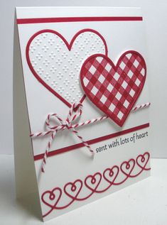 a red and white card with two hearts on it