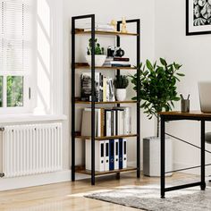 a room with a desk, bookshelf and chair in it that has plants on the shelves