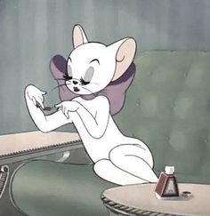 a cartoon mouse sitting on top of a table