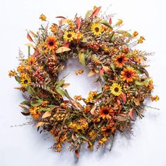 a wreath with sunflowers and other flowers on it