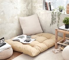 a living room filled with furniture and plants on top of the floor next to a window