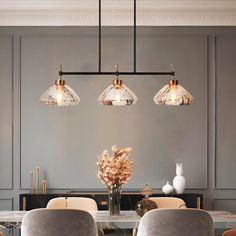 an elegant dining room with gray walls and gold accents