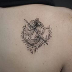 the back of a woman's shoulder with a tattoo on it