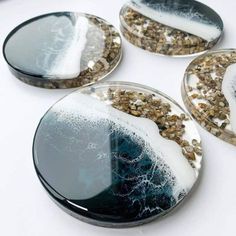 four plates with different designs on them sitting on a counter top next to each other