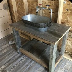 an old fashioned sink sits in the corner of a room with wooden walls and flooring