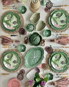 a table topped with lots of plates and flowers