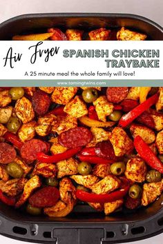 an air fryer filled with chicken, peppers and olives in the middle is text overlay that says air fryer spanish chicken tray