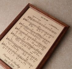 an old sheet music is framed in a wooden frame