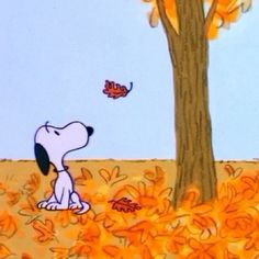 a cartoon dog sitting under a tree in the fall with leaves falling from it's branches