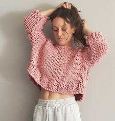 This knitted oversize-stitch crop, made with the thickest recycled cotton yarn, is such a unique and on-trend piece for your wardrobe.  Although it is thick, it can be worn all year around just as you would a cotton sweatshirt. It will keep you warm in the colder temperatures but made of part cotton, it will have a cooling effect in warmer temps.  The sleeves are 3/4 length and can be folded up for an even shorter look (the model in the 4th pic has one sleeve up and one sleeve down).   One size: Bulky Knit Sweater, Knitted Shrug, Crop Top Knit, Bulky Knit, Stitch Sweater, Sweater Crop, Recycled Yarn, Knitted Top, Top Crop