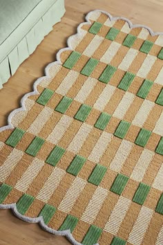 a green and beige rug on the floor