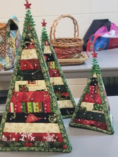 three small christmas trees sitting on top of a counter