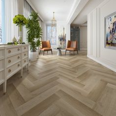 a room with white walls and wood flooring next to a large painting on the wall