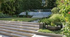 an outdoor garden with steps leading up to the house