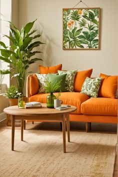 a living room with an orange couch, coffee table and potted plant