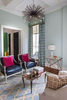 a living room filled with furniture and a chandelier