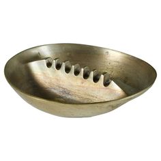 a metal bowl with holes in the middle