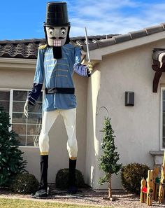 a statue of a man dressed as a nutcracker in front of a house