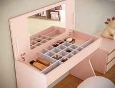 a pink vanity with drawers and a mirror