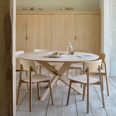 a wooden table with four chairs around it