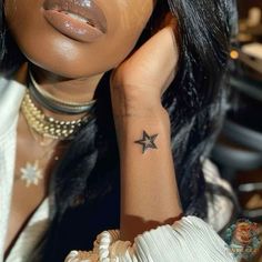 a woman with a star tattoo on her arm