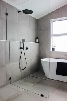 a bathroom with a bathtub, shower head and sink in it's corner