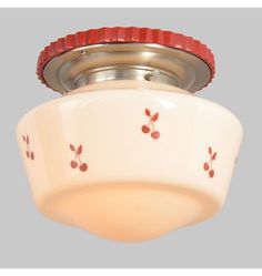 a white ceiling light with red trim on it