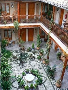 an indoor courtyard with potted plants and tables