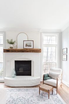 a living room with a white brick fireplace