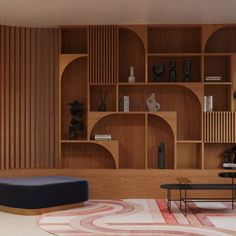 a living room filled with lots of wooden shelves next to a black table and chair