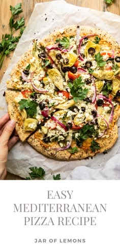 an easy mediterranean pizza recipe on parchment paper