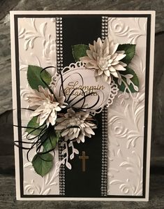 a card with flowers and a cross on it