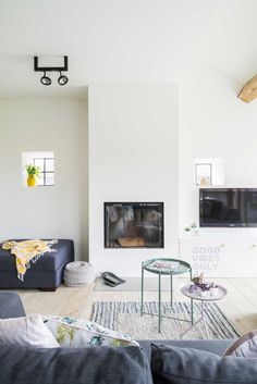 a living room filled with furniture and a fire place