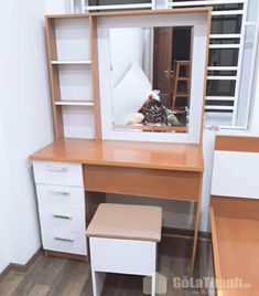 a desk with a mirror and some drawers