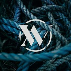 blue rope with white letters on it and an arrow in the middle, surrounded by smaller ropes