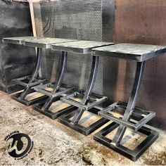 three metal tables sitting next to each other on top of a table covered in dirt