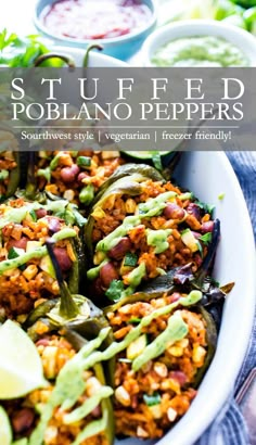 stuffed poblaano peppers in a white bowl with limes and salsa on the side