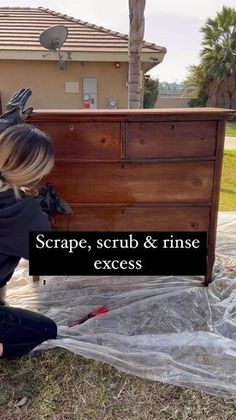 a woman kneeling on the ground next to a chest and rinse excessing it