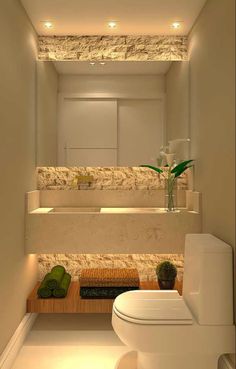 a bathroom with a toilet, sink and bathtub in the center is illuminated by recessed lighting