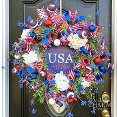 a patriotic wreath is hanging on the front door