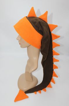 an orange and brown hat on top of a mannequin head