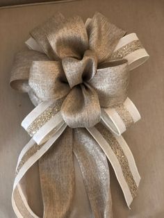 a close up of a large bow on a box with ribbon around the top and bottom