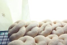 a bunch of doughnuts sitting on top of a cooling rack